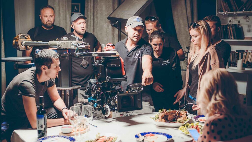 Film crew discuss how to art direct the objects in shot